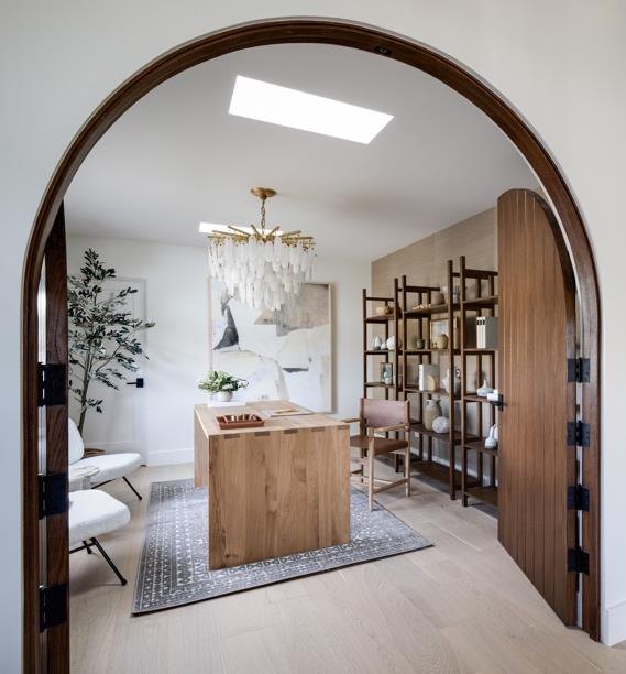 An arched doorway into a styled home office