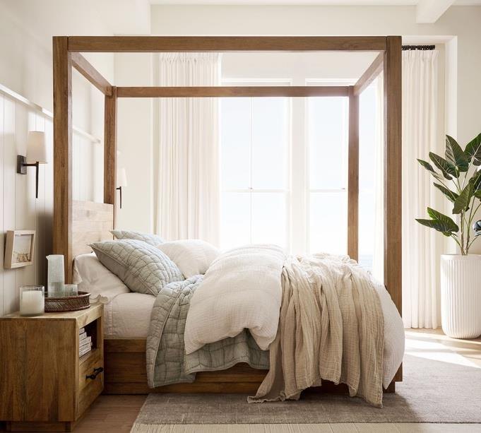 A calm bedroom with oak canopy bed