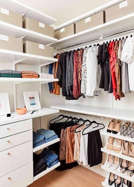 A walk-in closet with organized clothing